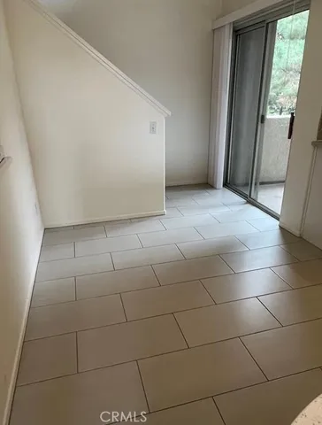 a view of a livingroom with an empty space and a window