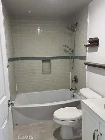 a bathroom with a toilet and a bathtub