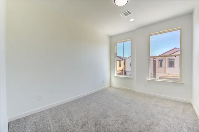 a view of kitchen with furniture and refrigerator