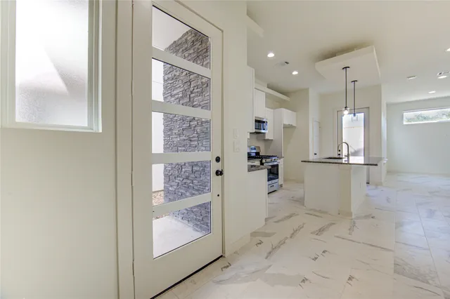 a view of staircase with lots of frames on wall