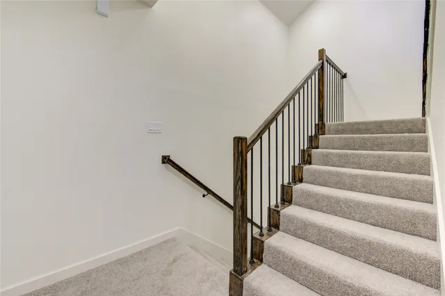 an empty room with windows and ceiling fan