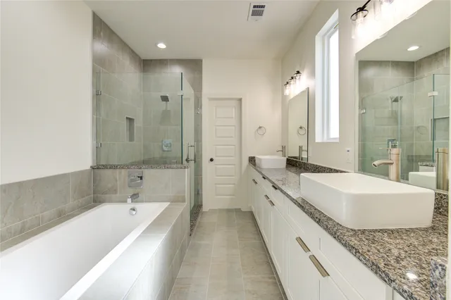 a bathroom with a bathtub and shower