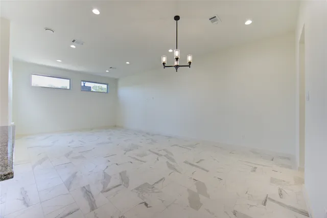 a kitchen with stainless steel appliances granite countertop a sink a stove a refrigerator and white cabinets