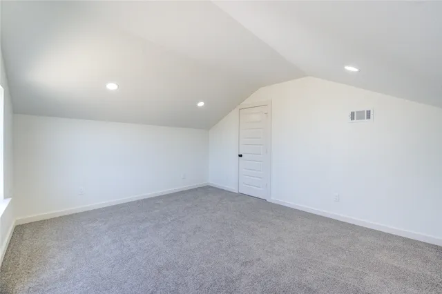 an empty room with closet and natural light