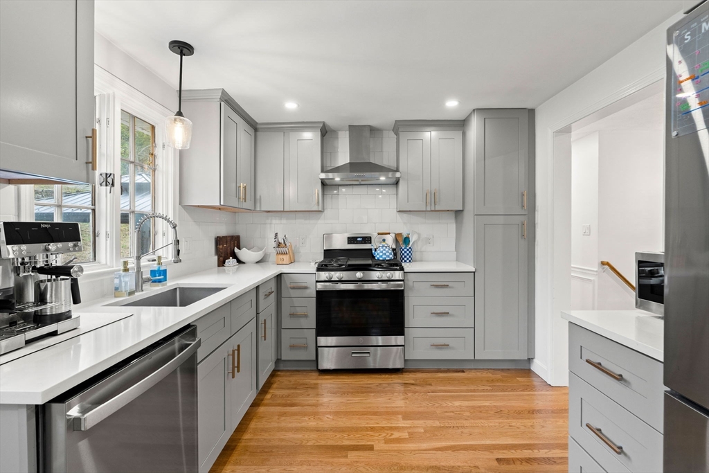 92 Moffatt Road Salem, MA 01970 - Photo 11 of 42 a kitchen with stainless steel appliances granite countertop a sink stove and refrigerator