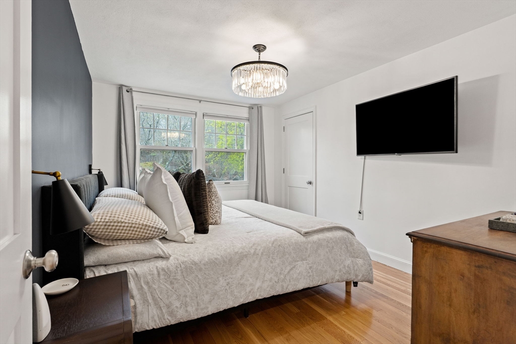 92 Moffatt Road Salem, MA 01970 - Photo 15 of 42 a bedroom with a bed and a flat screen tv