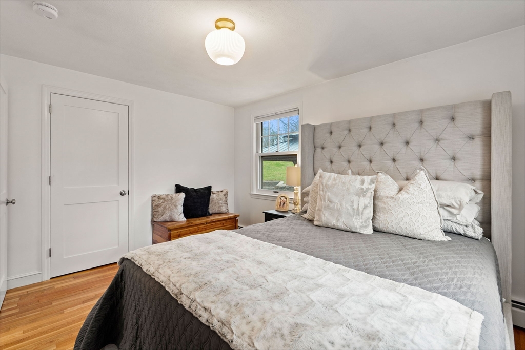 92 Moffatt Road Salem, MA 01970 - Photo 19 of 42 a spacious bedroom with a large bed and a flat tv screen on dresser