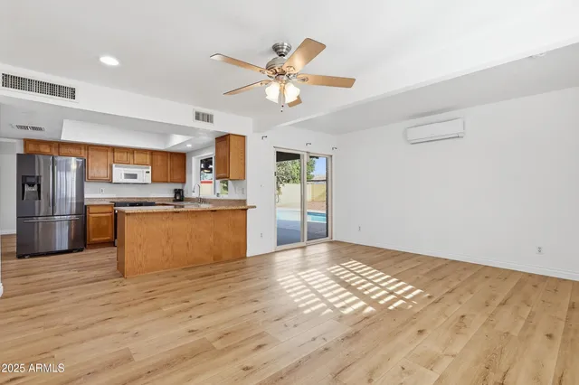 a view of a kitchen with a sink cabinets and wooden floor