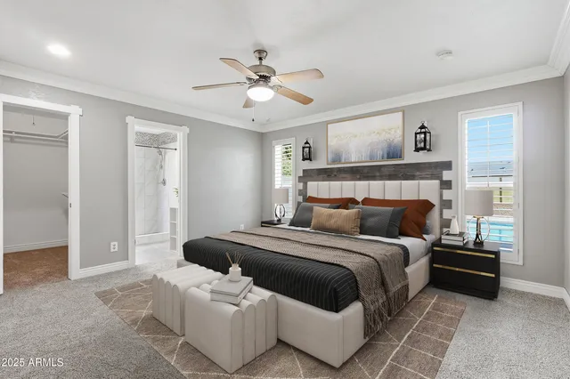 a bedroom with a large bed and a chandelier