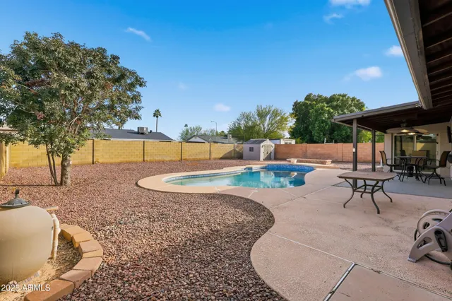 swimming pool view with a seating space