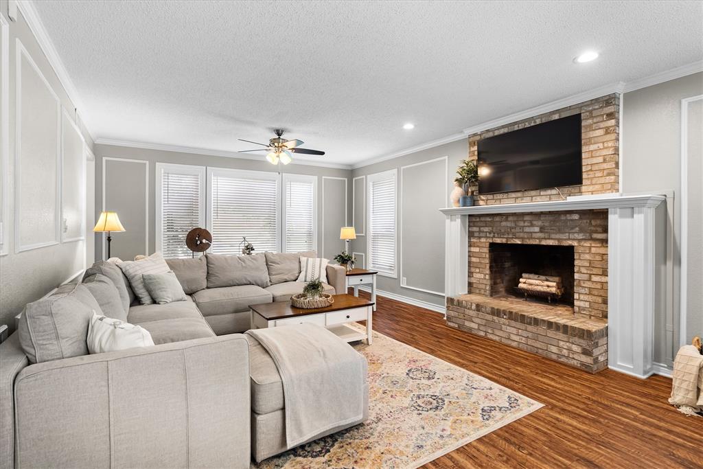 410 Simmons Road Double Oak, TX 75077 - Photo 10 of 40 Bright, spacious living room with fireplace and abundant natural light.
