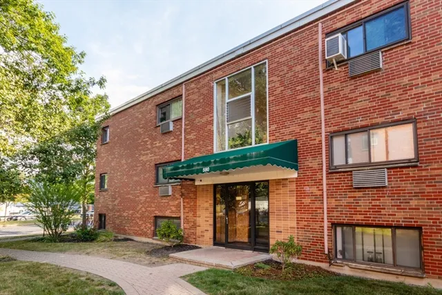 front view of a brick house with a yard