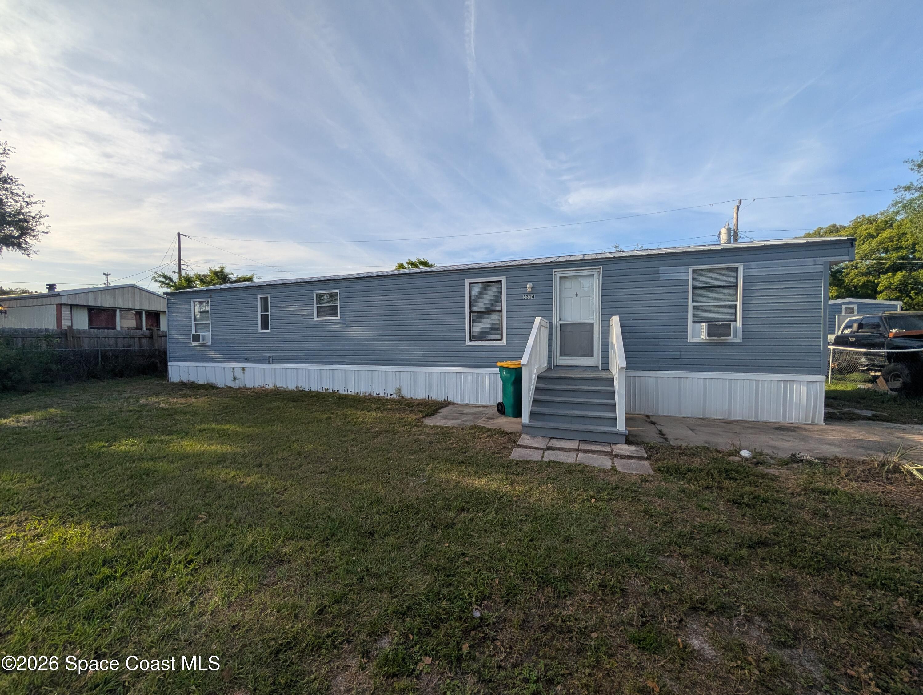 3314 Kittles Street Mims, FL 32754 - Photo 4 of 9 a view of a house with a yard