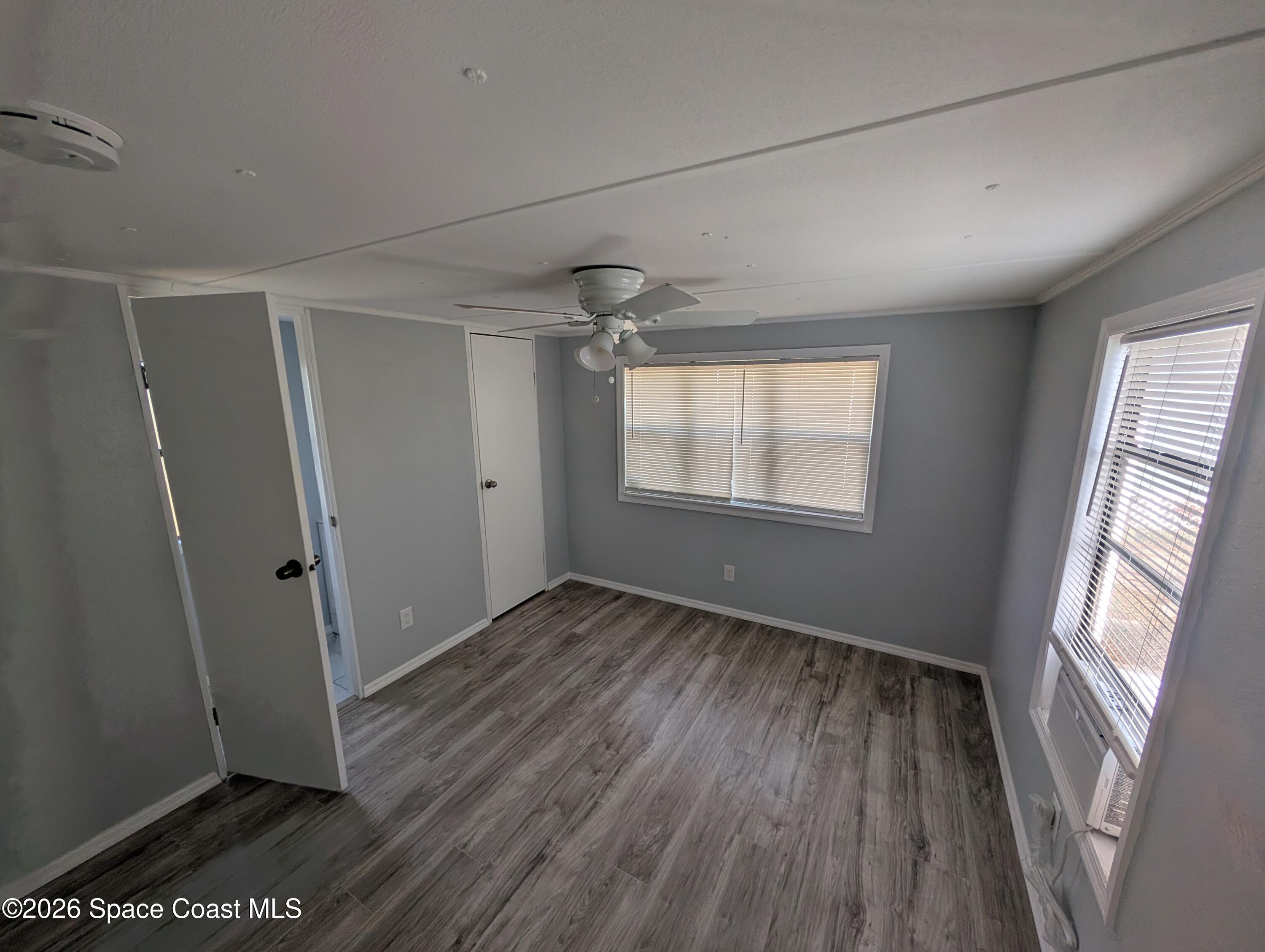 3314 Kittles Street Mims, FL 32754 - Photo 5 of 9 an empty room with wooden floor and windows