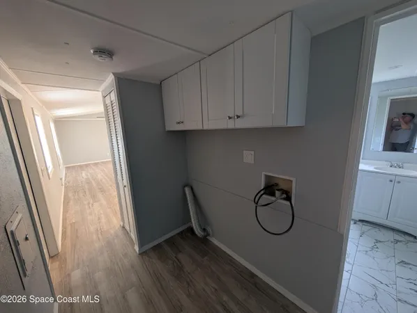 a view of an entryway with wooden floor