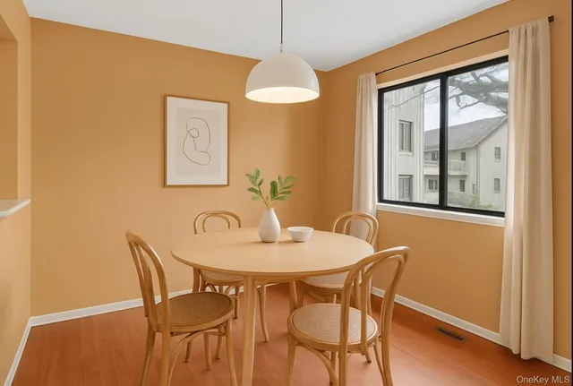 a dining room with furniture and window