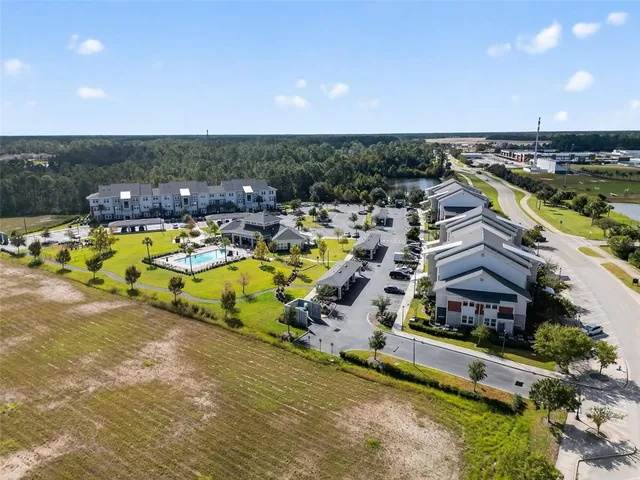 an aerial view of a house with a garden and lake view