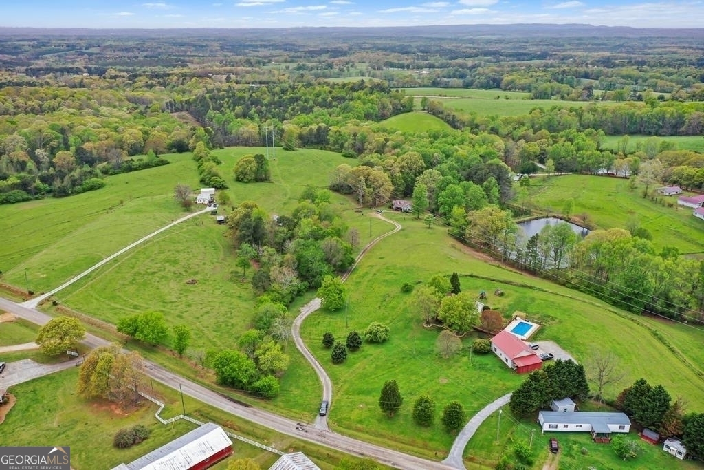 80 Upper Caldwell Road Bowdon, GA 30108 - Photo 25 of 33 an aerial view of green landscape with trees houses and mountain view