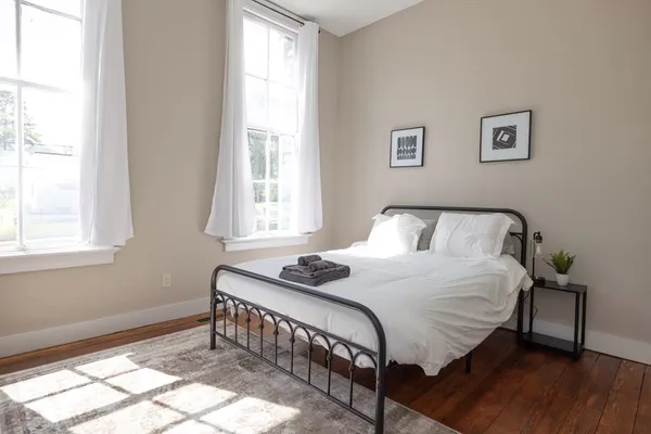 a bedroom with a bed and a potted plant