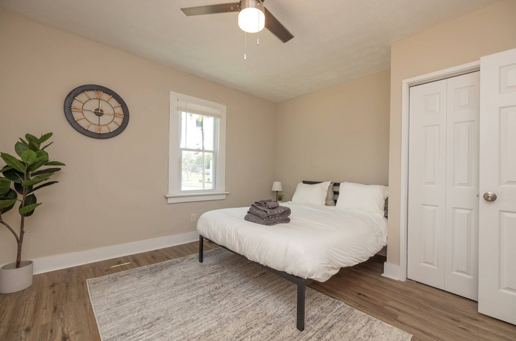 1300 18th Street Columbus, GA 31901 - Photo 17 of 38 a bedroom with a bed and a potted plant