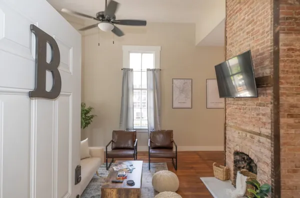 a living room with furniture and wooden floor