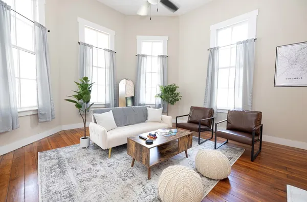 a living room with furniture fireplace and flat screen tv