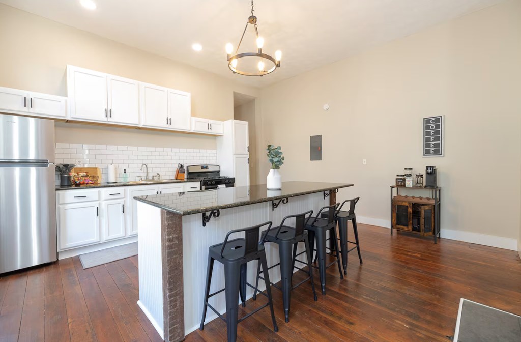1300 18th Street Columbus, GA 31901 - Photo 22 of 38 a kitchen with a table chairs stove and cabinets