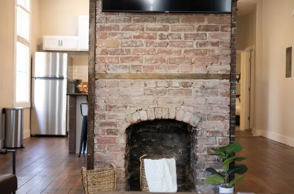 a kitchen with stainless steel appliances granite countertop a sink a refrigerator and a white cabinets
