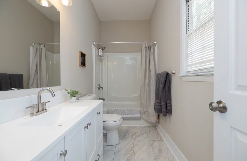 1300 18th Street Columbus, GA 31901 - Photo 28 of 38 a bathroom with a double vanity sink toilet and shower