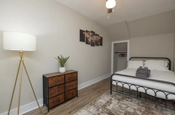 a bedroom with a bed and a potted plant