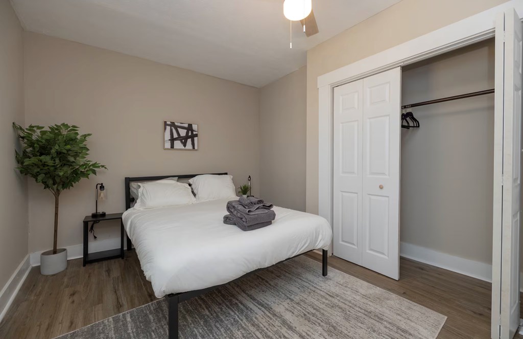 1300 18th Street Columbus, GA 31901 - Photo 30 of 38 a bedroom with a bed and a potted plant