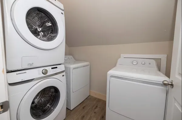 a kitchen with granite countertop white cabinets and window