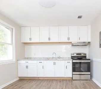 a view of a kitchen with a refrigerator and window
