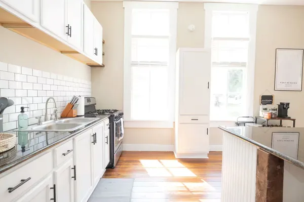 a kitchen with a sink stove and cabinets