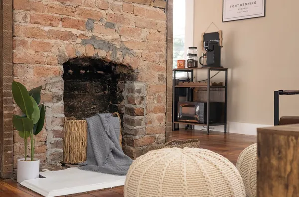 a living room with furniture potted plant and a large window