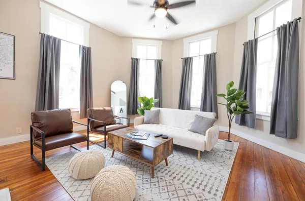 a living room with furniture and a fireplace