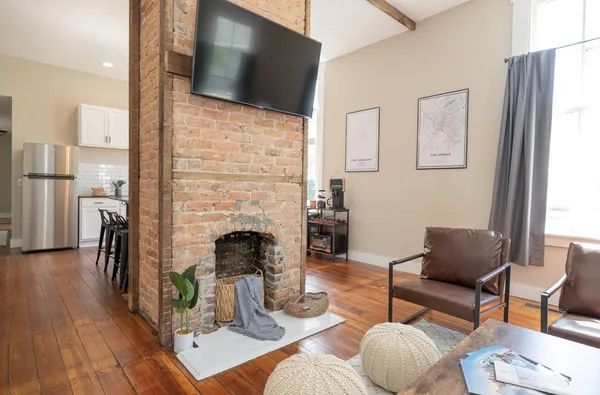 a view of a dining room with furniture and wooden floor