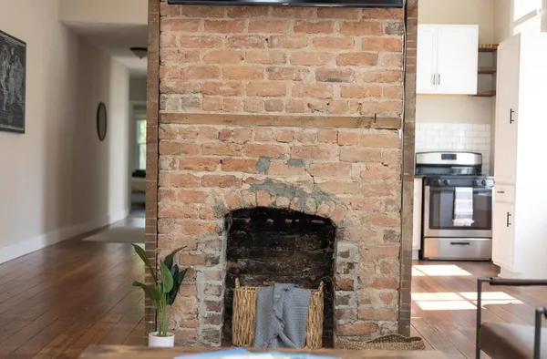 a kitchen with appliances cabinets and chair