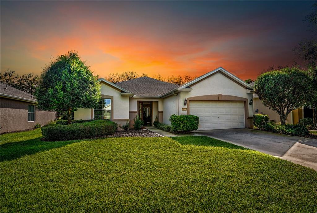 9435 Southwest 66th Loop Ocala, FL 34481 - Photo 1 of 1 a front view of a house with a yard and garage