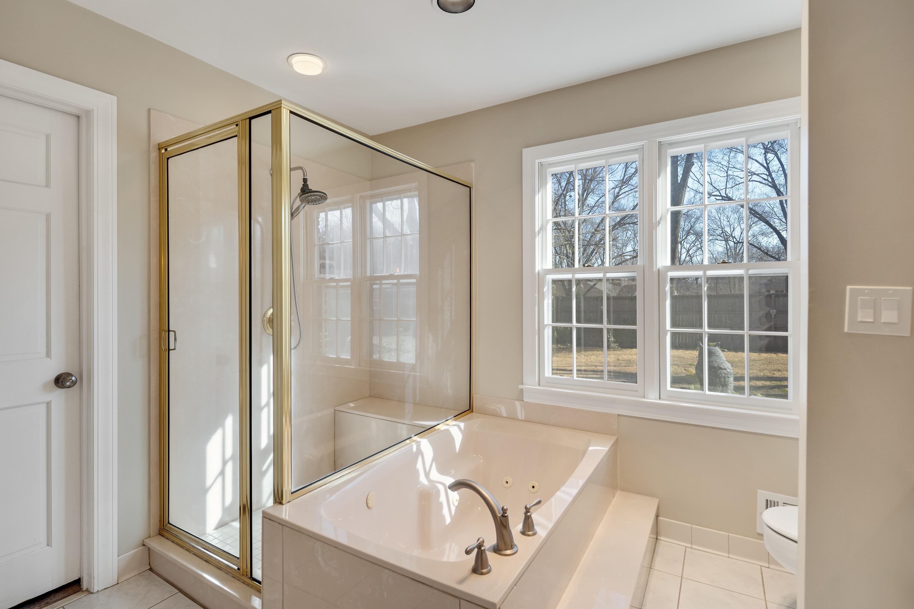 2072 Kirby Road Memphis, TN 38119 - Photo 15 of 38 a bathroom with a tub shower and sink