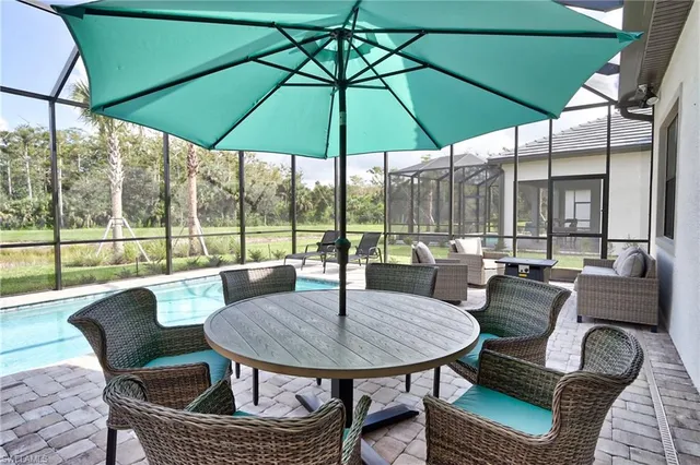 a view of a patio with a table chairs and a umbrella