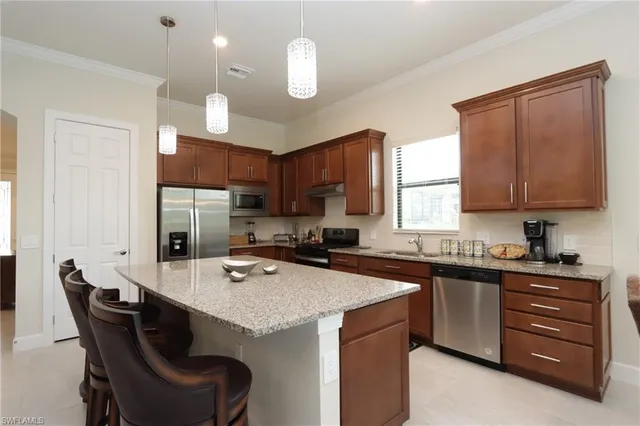 a kitchen with a sink a stove a refrigerator and cabinets