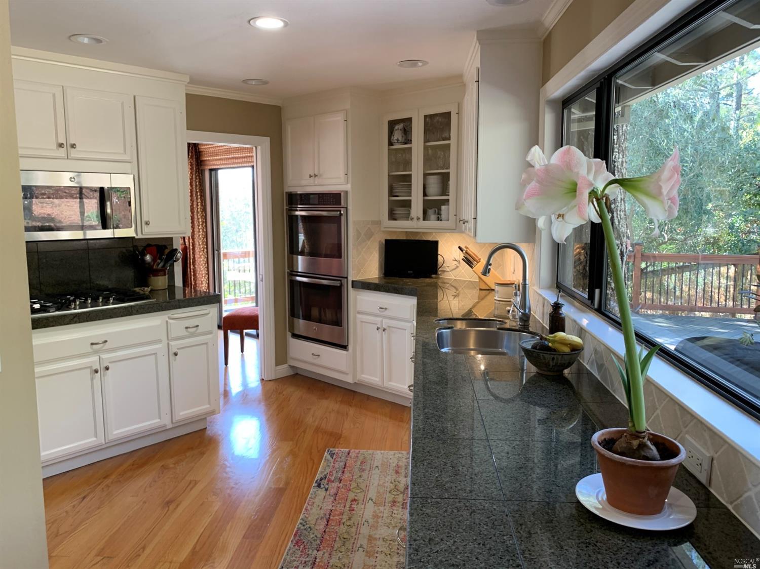 a kitchen with sink refrigerator and cabinets