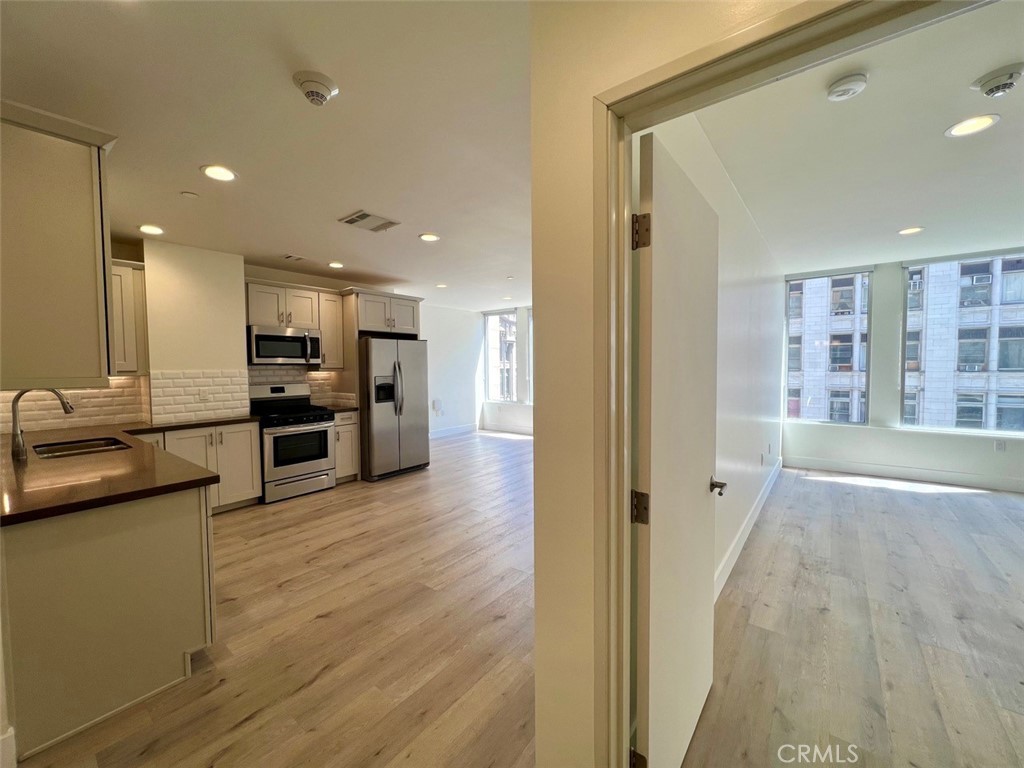 314 6th, Unit 506 Los Angeles, CA 90014 - Photo 1 of 12 a view of kitchen with stainless steel appliances kitchen island wooden floor and living room