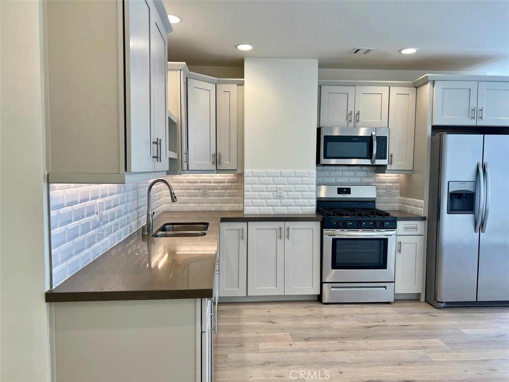 314 6th, Unit 506 Los Angeles, CA 90014 - Photo 2 of 12 a kitchen with stainless steel appliances granite countertop a sink stove and refrigerator