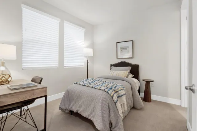 a bedroom with a bed and a table