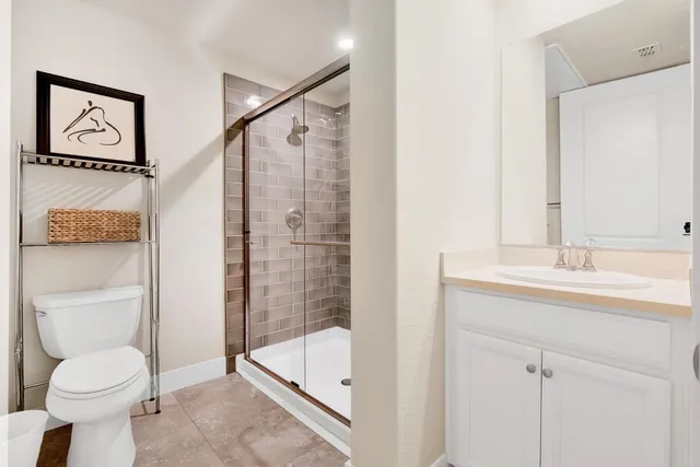 a bathroom with a toilet sink and shower