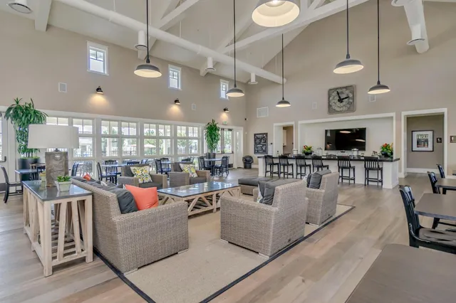 a living room with fireplace furniture and a large window