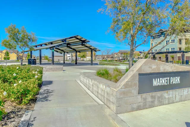 a view of a street with a building and trees in the background