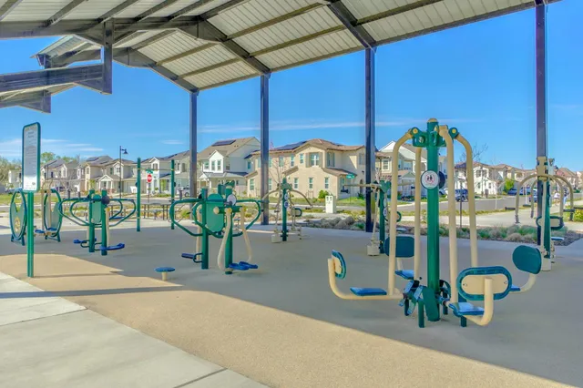 a view of a swimming pool with a lawn chairs under an umbrella